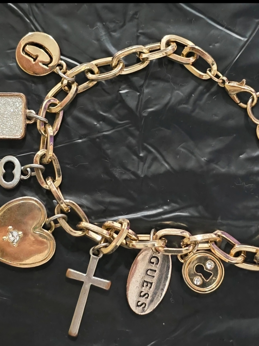 GUESS Gold Multi-Charm Bracelet with Cross and Heart Charms